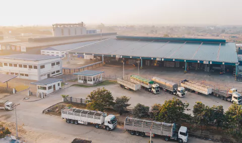 aerialviewfactorytrucksparkednearwarehousedaytime1I1693